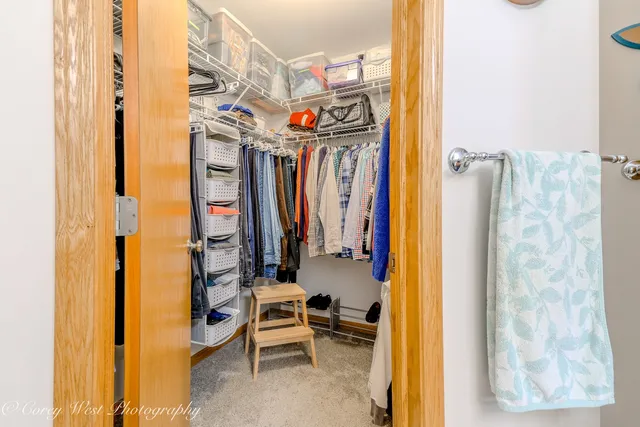 a view of walk in closet with clothes