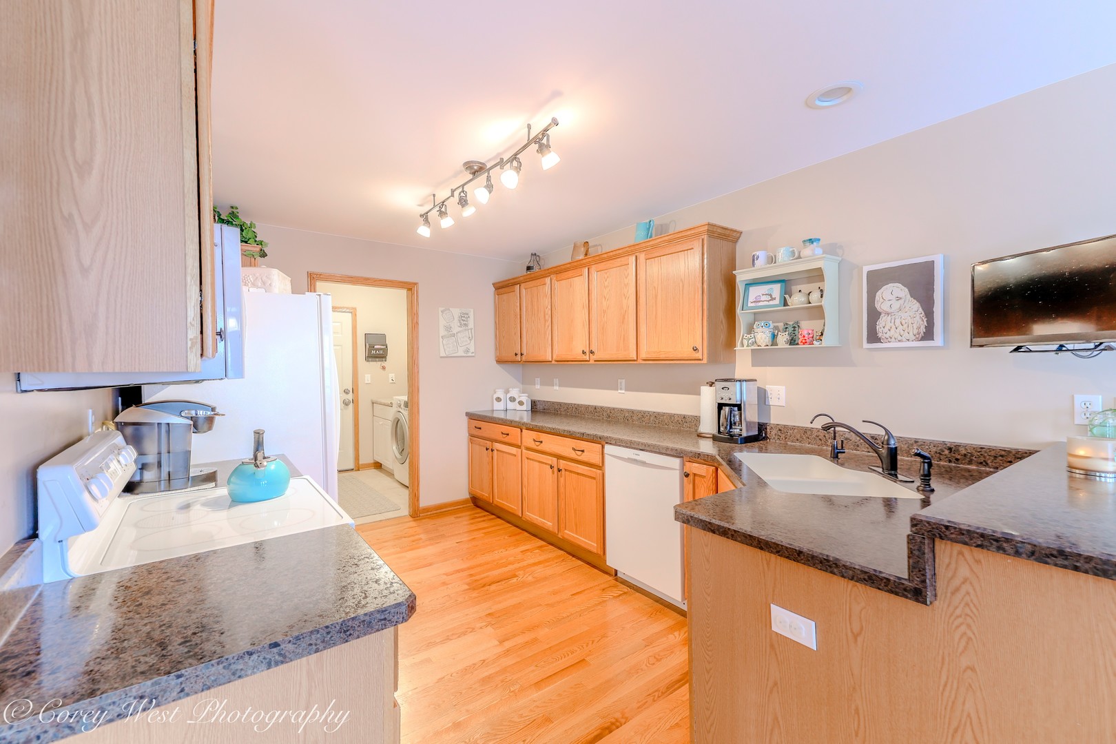 708 Nancy Court Sycamore, IL 60178 - Photo 13 of 29 a large kitchen with granite countertop a sink and a stove top oven with wooden floor