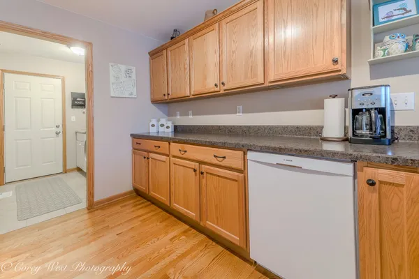 a kitchen with stainless steel appliances granite countertop a refrigerator and cabinets