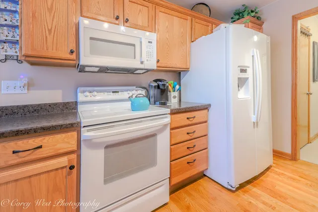 a kitchen with a stove cabinets and a refrigerator