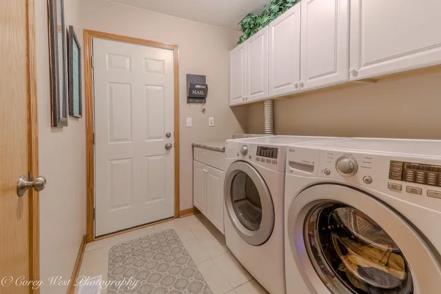 a view of storage and utility room with washer and dryer