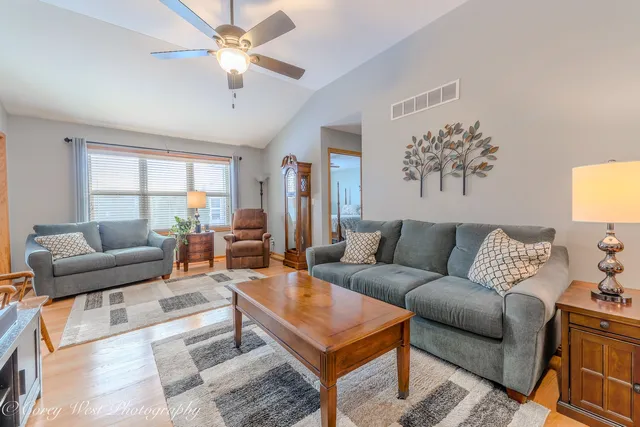 a living room with furniture a chandelier and a window