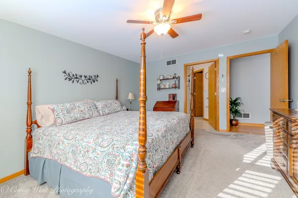 a bedroom with a large bed and a chandelier
