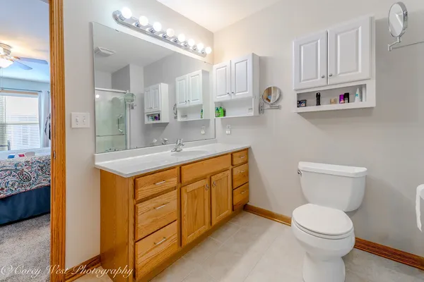 a spacious bathroom with a sink a toilet and a mirror