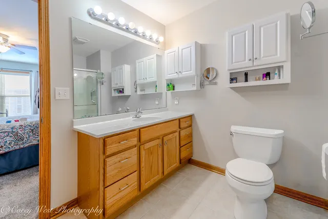 a spacious bathroom with a sink a toilet and a mirror