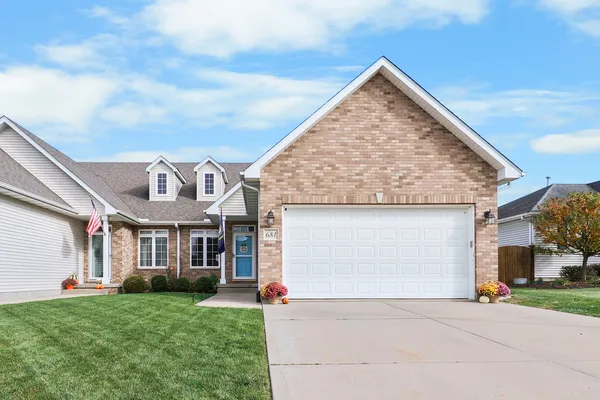 a view of a house with a yard and garage