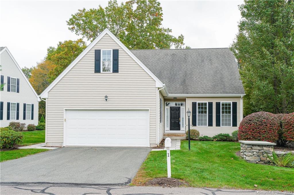 1 Kenington Road, Unit 1 Avon, CT 06001 - Photo 1 of 1 a front view of a house with a yard and garage