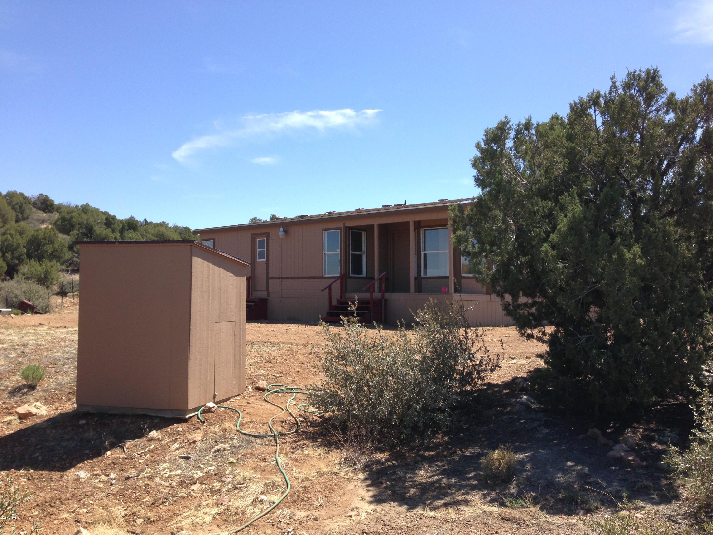 320 Knight Creek Road Kingman, AZ 86401 - Photo 20 of 30 Well house and front of house