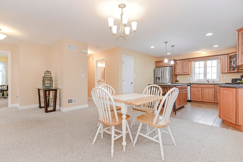 522 Detroit Street Fall River, MA 02721 - Photo 8 of 32 a view of a dining room with furniture and a chandelier