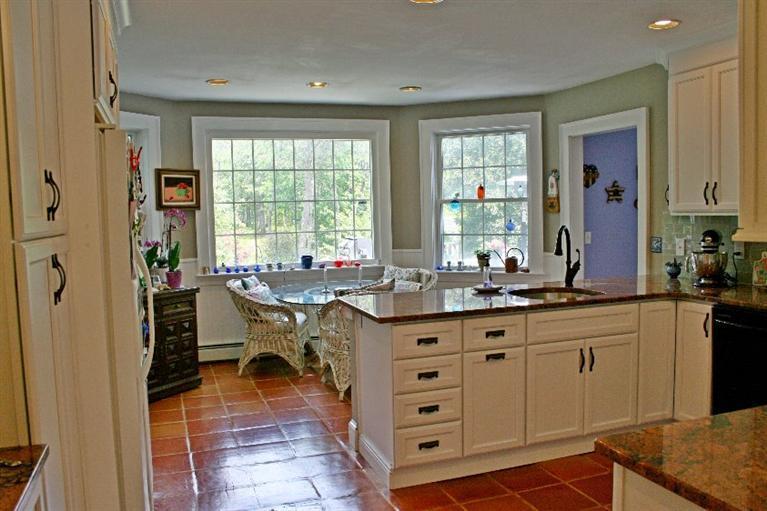 275 Quasons Path Brewster, MA 02631 - Photo 11 of 32 a very nice looking kitchen with granite countertop a stove a sink a dining table and chair