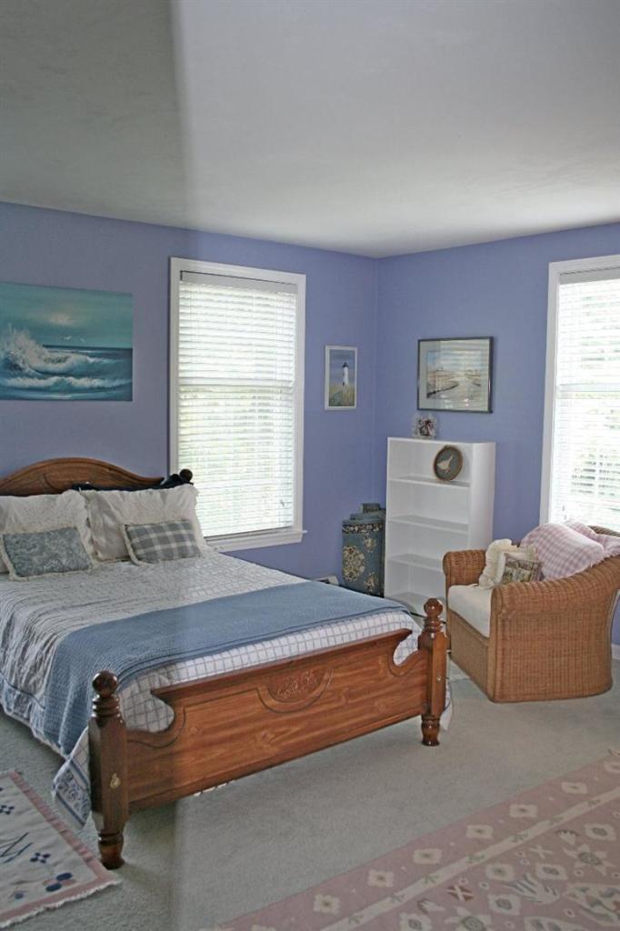 275 Quasons Path Brewster, MA 02631 - Photo 24 of 32 a spacious bedroom with a bed and a couch