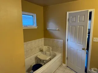 a bathroom with a tub a sink and a shower