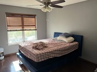 a bedroom with a bed and window