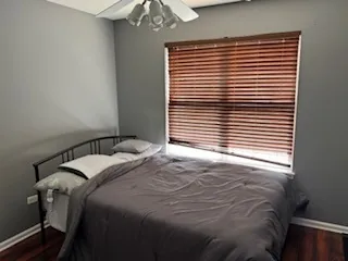 a bedroom with a bed and a window