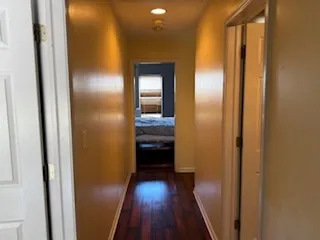 a view of a hallway with wooden floor