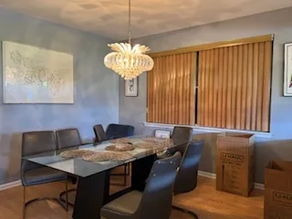 a view of a dining room with furniture wooden floor and chandelier