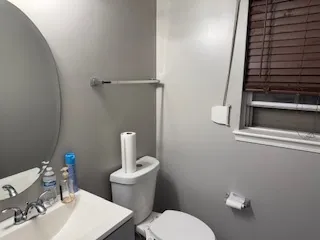 a white toilet sitting next to a bathroom sink