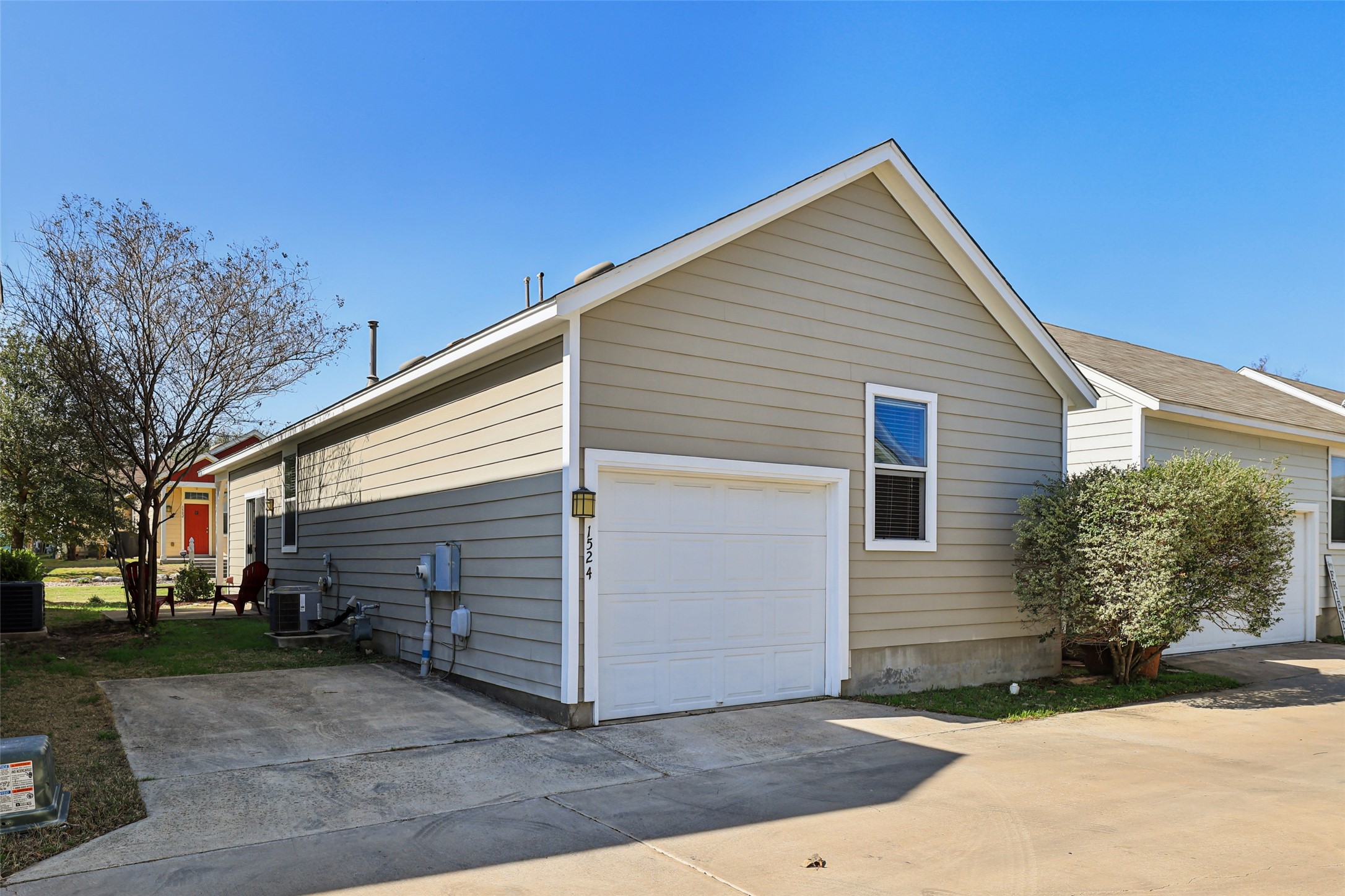 1524 Sanders Kyle, TX 78640 - Photo 29 of 37 View of side of property featuring a garage and a cooling unit