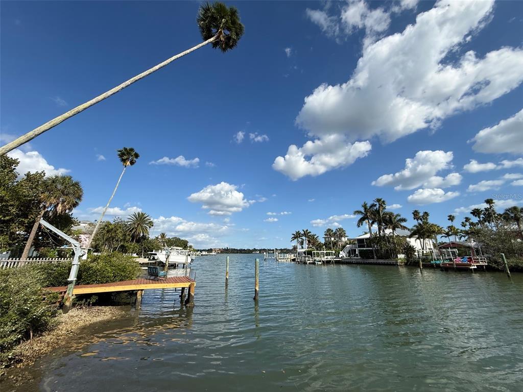a view of a lake with chairs
