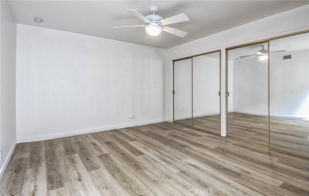 6061 Sierra Bravo Road Irvine, CA 92603 - Photo 14 of 22 a view of a livingroom with wooden floor and a ceiling fan