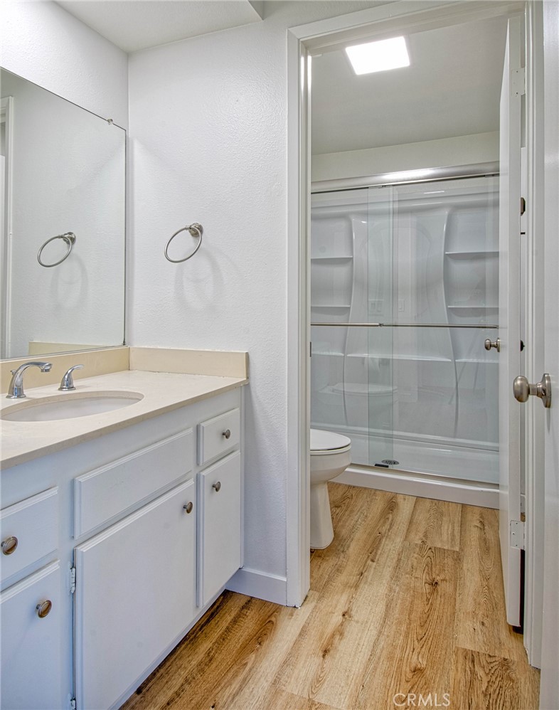 6061 Sierra Bravo Road Irvine, CA 92603 - Photo 18 of 22 a bathroom with a granite countertop sink a toilet and shower