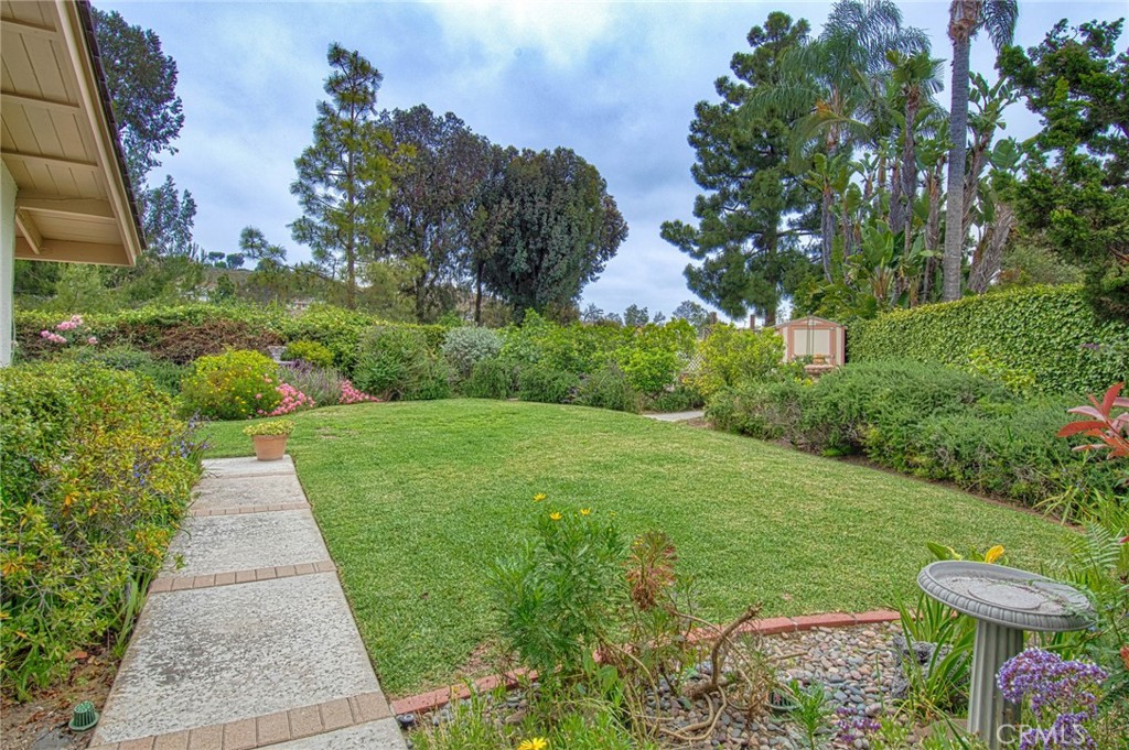6061 Sierra Bravo Road Irvine, CA 92603 - Photo 19 of 22 a view of a garden with plants and a lawn chairs
