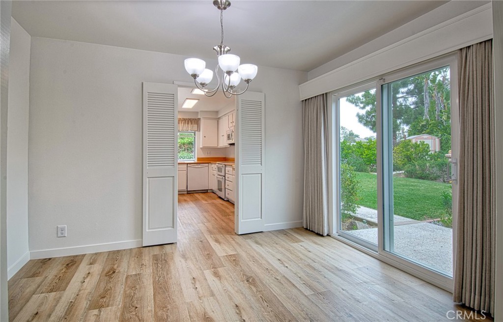 6061 Sierra Bravo Road Irvine, CA 92603 - Photo 10 of 22 a view of a room with wooden floor staircase and a kitchen