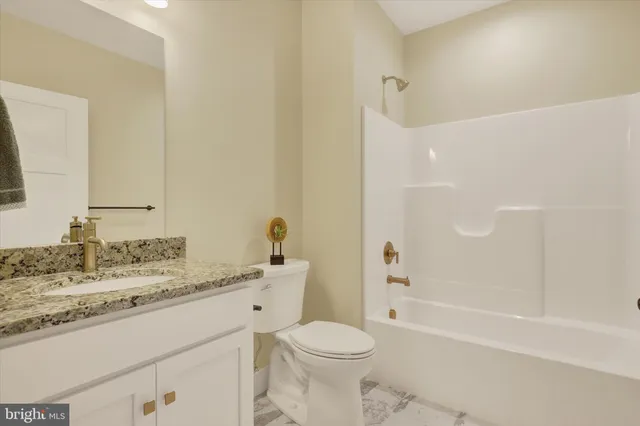 a bathroom with a sink toilet vanity and shower