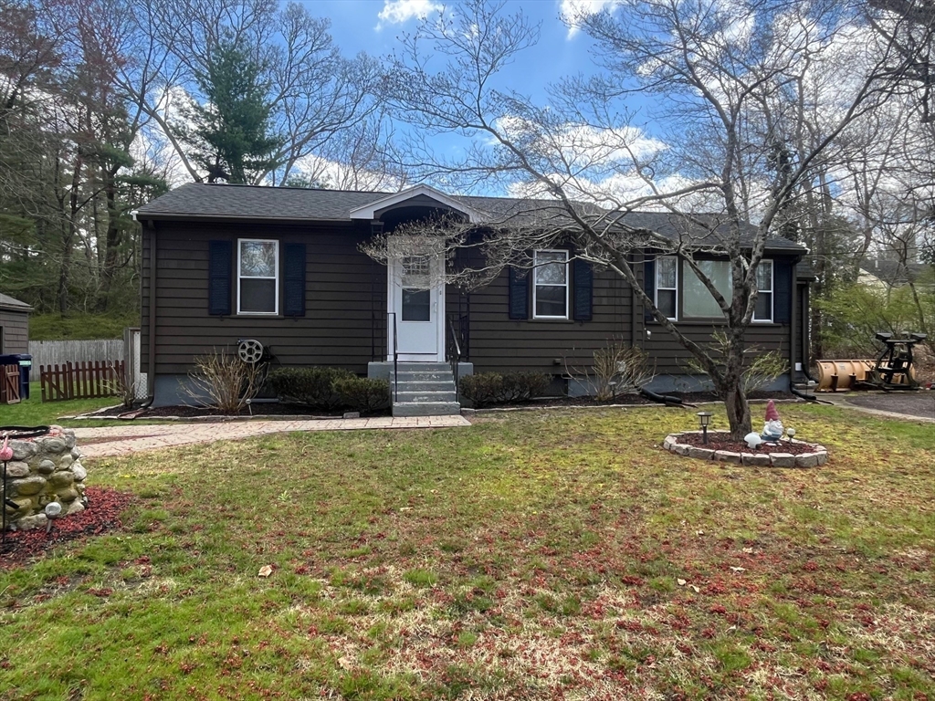 a front view of a house with a yard