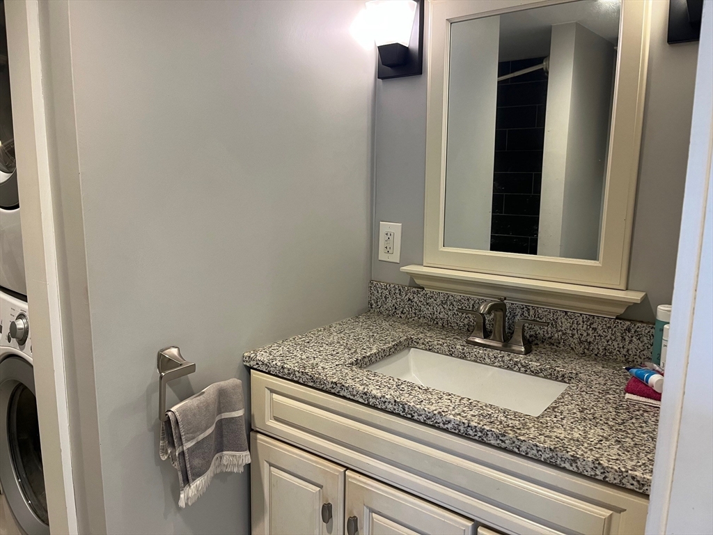 4 Summit Street Waltham, MA 02451 - Photo 12 of 22 a bathroom with a granite countertop sink and a mirror