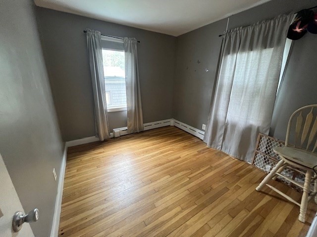 4 Summit Street Waltham, MA 02451 - Photo 15 of 22 a view of an empty room with wooden floor and a window