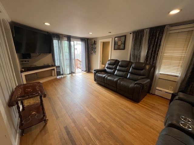4 Summit Street Waltham, MA 02451 - Photo 6 of 22 a living room with furniture and a flat screen tv