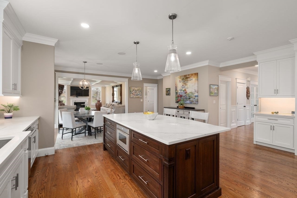 56 Blossomcrest Road Lexington, MA 02421 - Photo 9 of 29 a large kitchen with kitchen island a sink a stove a dining table and chairs