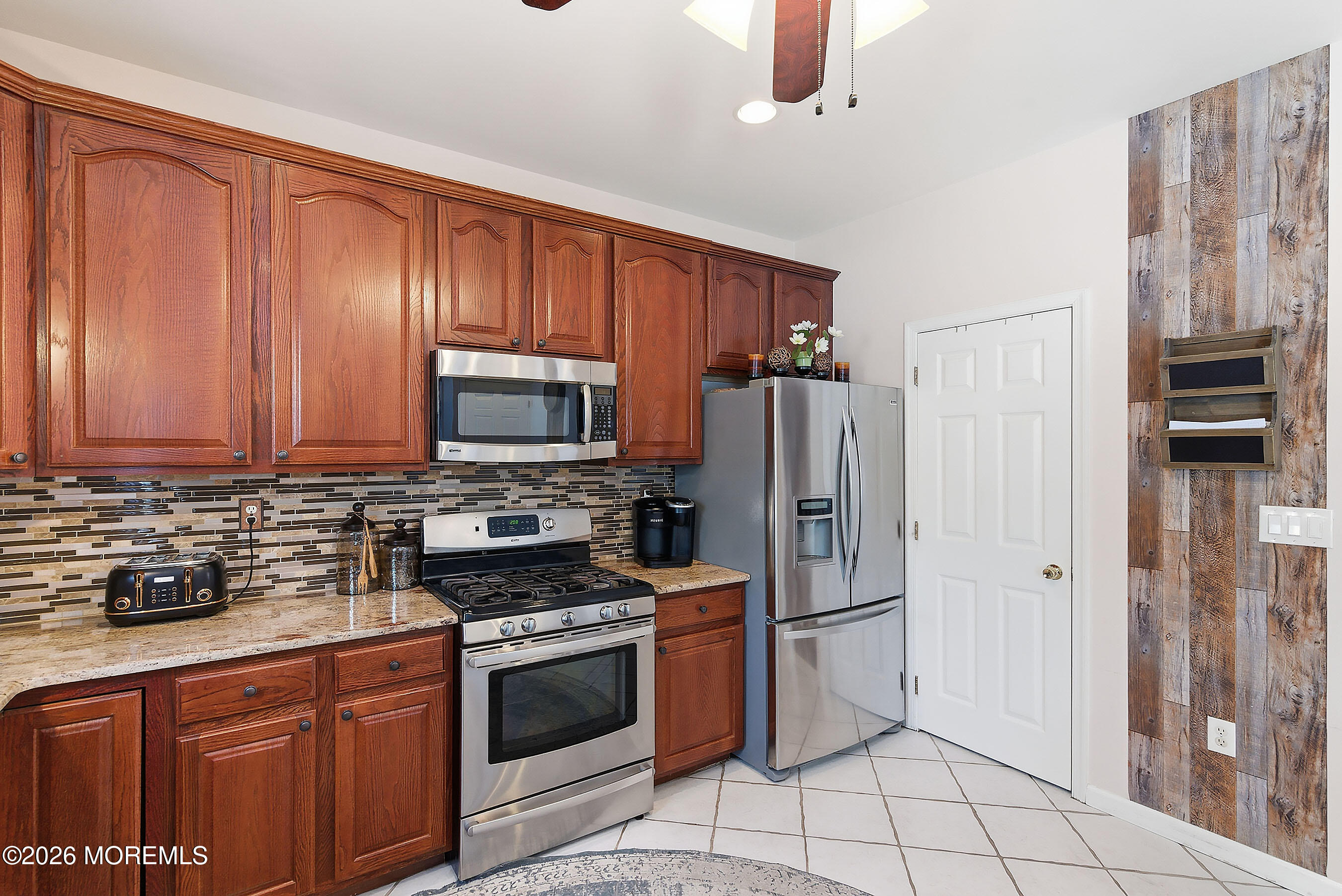 9 Kindling Way Jackson, NJ 08527 - Photo 16 of 33 a kitchen with stainless steel appliances granite countertop a refrigerator stove and cabinets