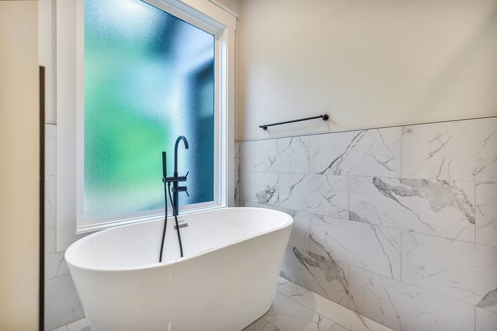 1422 Hunters Trail Anderson, SC 29625 - Photo 21 of 41 Indulge in a luxurious soak with this elegant freestanding bathtub, accented by sophisticated marble-patterned tile.