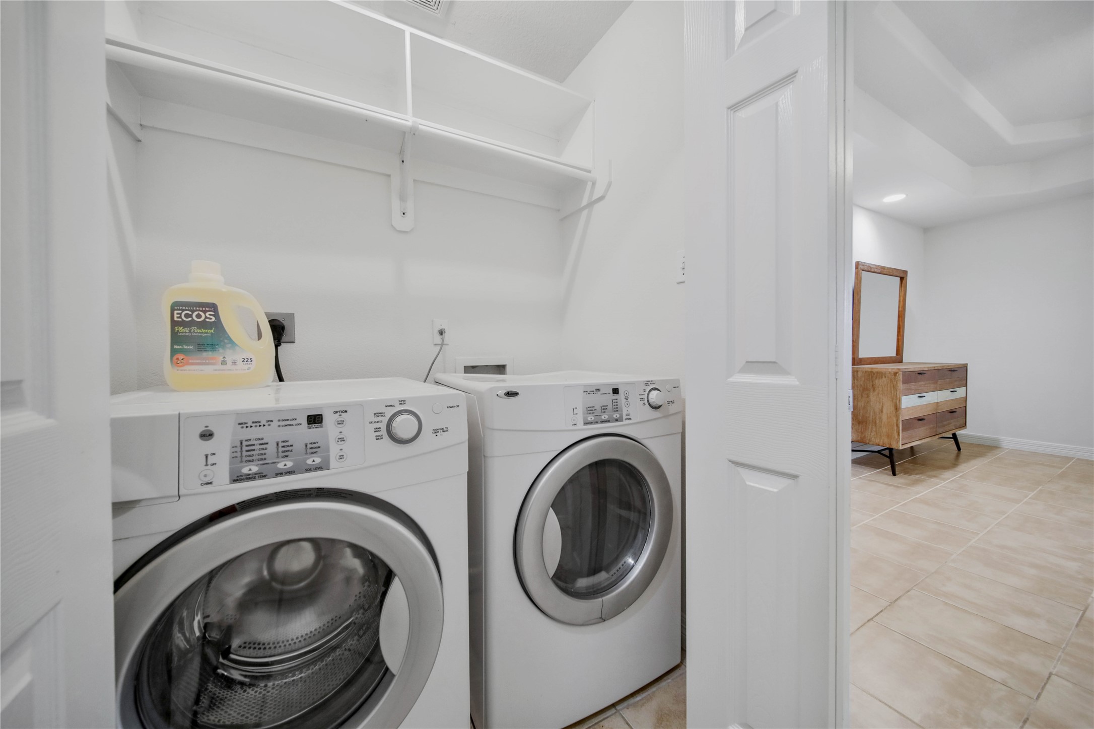 4943 Gammage Street Houston, TX 77021 - Photo 13 of 22 The utility room is inside the home and comes equipped with a washer and dryer. There is a hanging rod and shelf for storage.