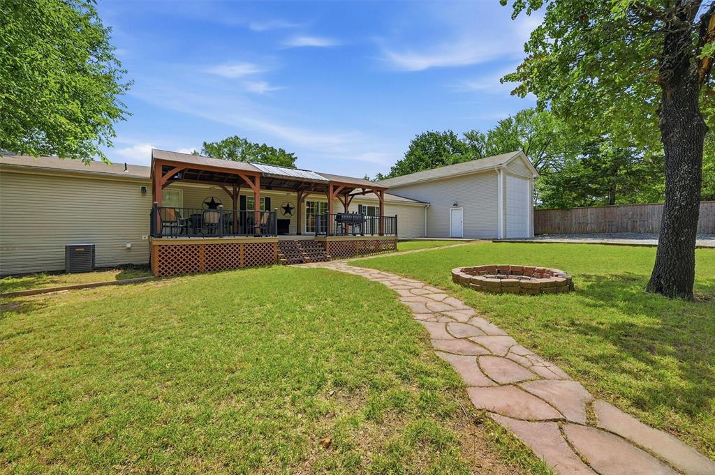 212 Sunset Road Pottsboro, TX 75076 - Photo 27 of 40 a view of a house with backyard and porch