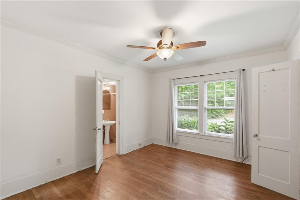 1424 Emory Road Northeast Atlanta, GA 30306 - Photo 18 of 36 a view of an empty room with a window and wooden floor