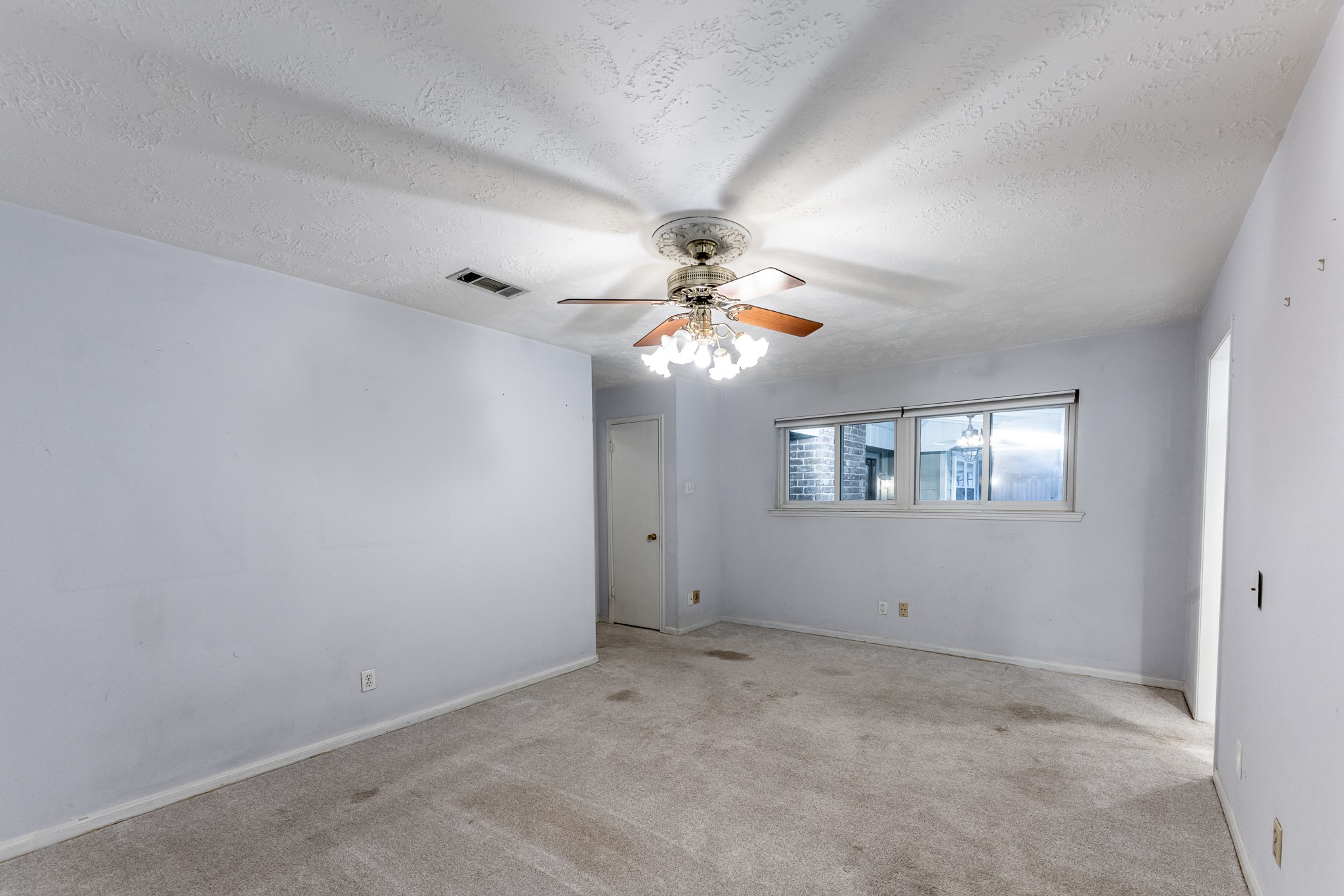 206 Hickory Ridge Drive Shenandoah, TX 77381 - Photo 19 of 35 a view of a chandelier fan and window in an empty room