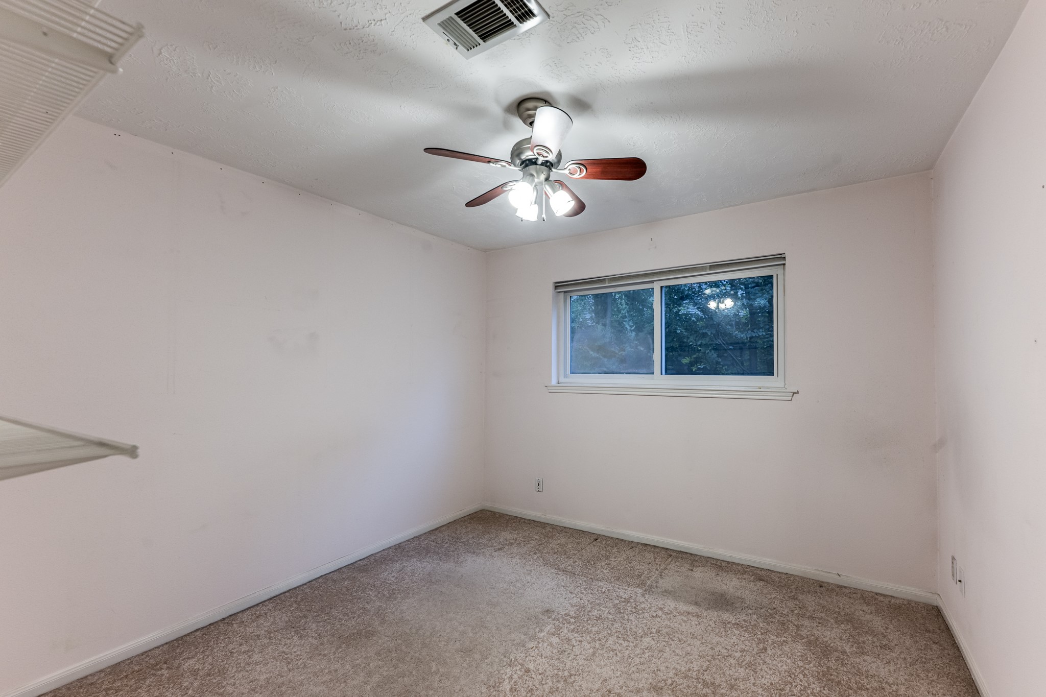 206 Hickory Ridge Drive Shenandoah, TX 77381 - Photo 24 of 35 an empty room with a window and ceiling fan