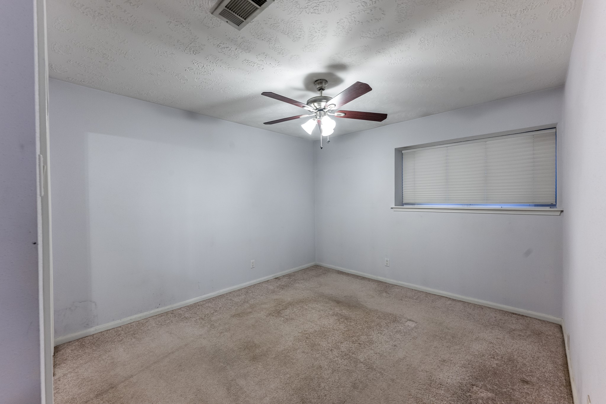 206 Hickory Ridge Drive Shenandoah, TX 77381 - Photo 25 of 35 an empty room with a window and a fan