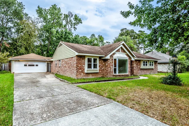 a front view of house with yard and green space
