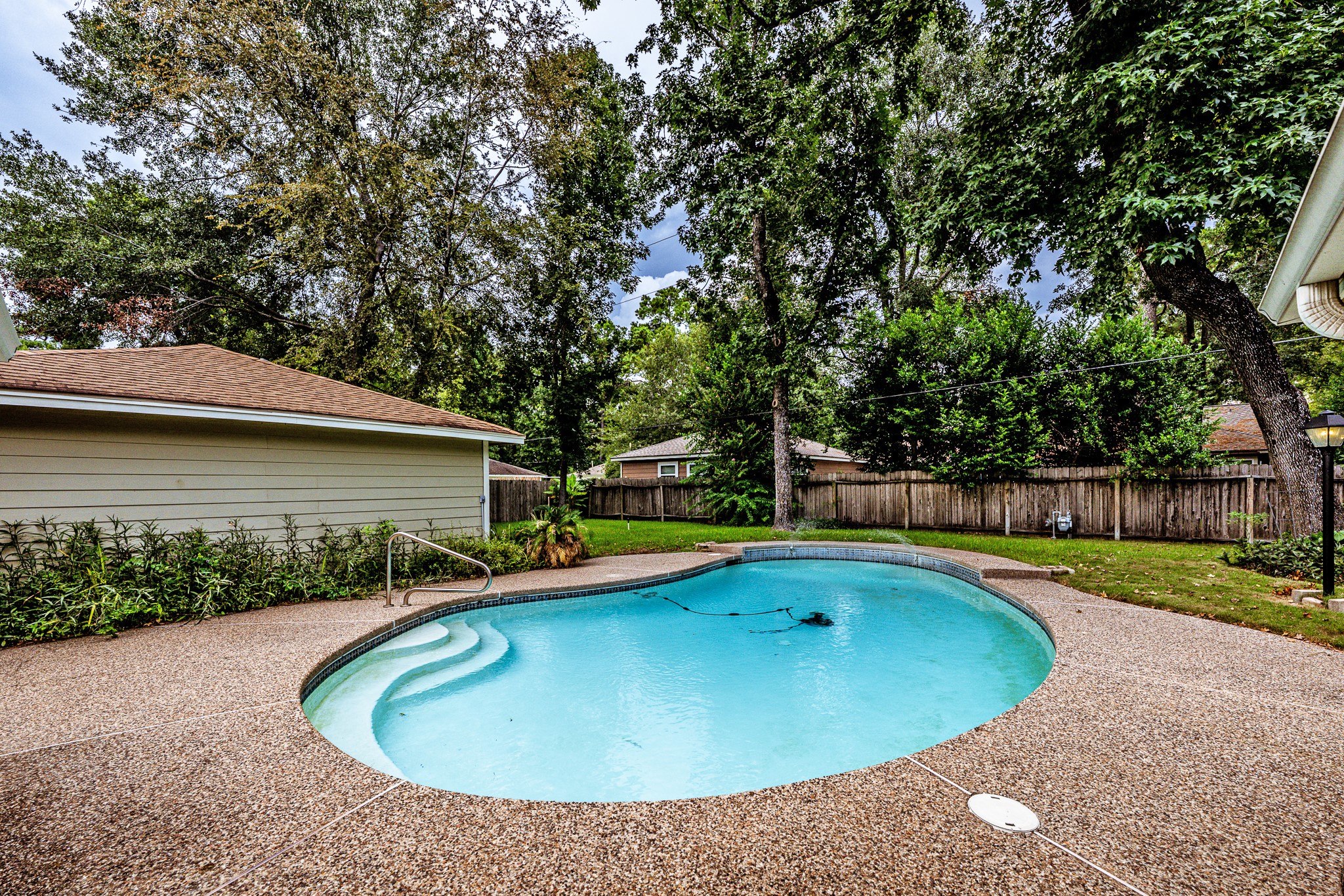 206 Hickory Ridge Drive Shenandoah, TX 77381 - Photo 34 of 35 a view of a swimming pool with a yard and plants