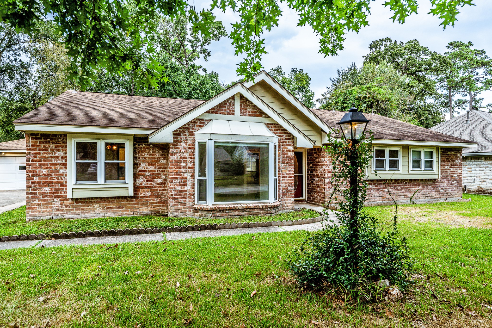 206 Hickory Ridge Drive Shenandoah, TX 77381 - Photo 4 of 35 a front view of a house with a yard