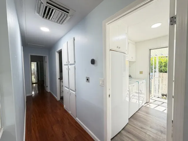 a view of hallway with wooden floor