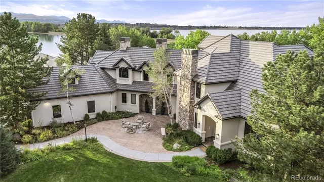 a front view of a house with a yard table and chairs
