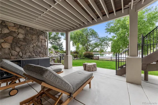 a view of a deck with wooden floor and fence next to a lake