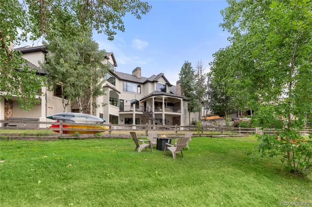 a living room with furniture a bookshelf and a window