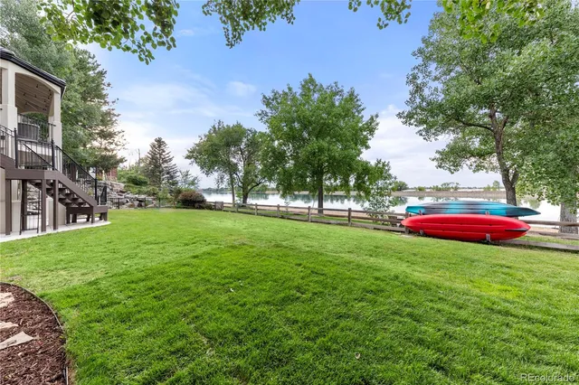 a living room with furniture large window and a fireplace