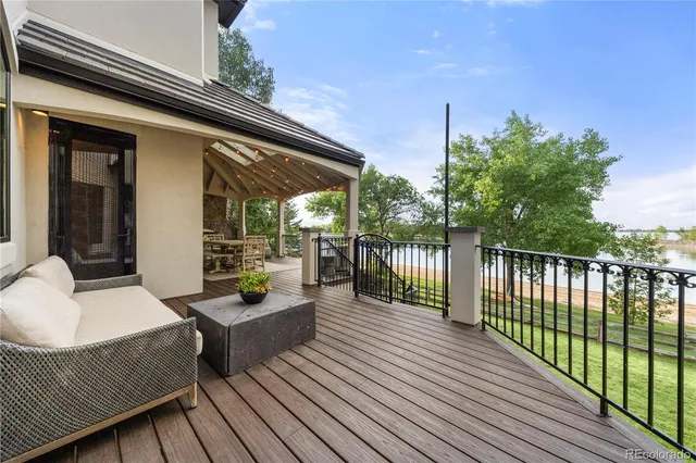 a large kitchen with stainless steel appliances granite countertop a sink a oven a stove and a wooden floors